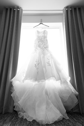 Wedding Dress Hung Beside Open Window