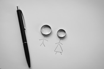 wedding rings on a white background in the form of little people