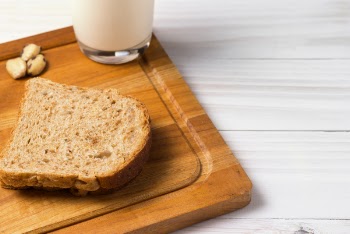 Wheat Bread Slice on Brown Wooden Board