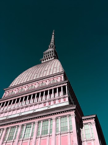 Whit and Pink Concrete Building Under Blue Sky