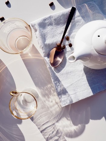 Whit Ceramic Teapot on Towel Near Spoon
