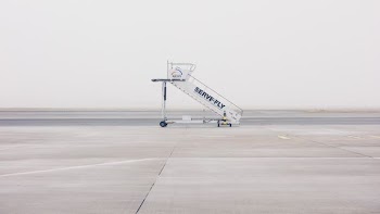 white airliner stairs on runway