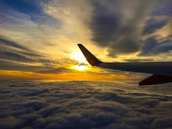White Airplane Flying on Blue and Grey Sky