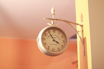 White Analog Clock Displaying 3:54