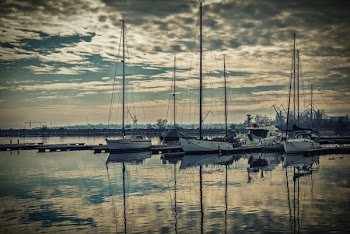 White and Black Boats Near Ocean Dock