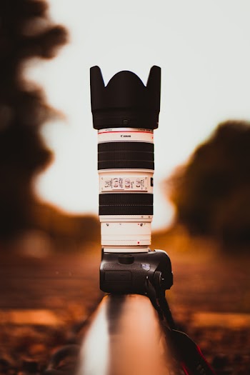 White and Black Canon Dslr Camera