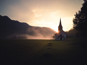 White and Black Church on Green Grass Field