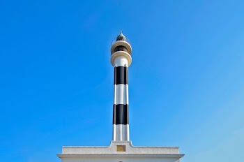 white and black concrete building under clear blue sky