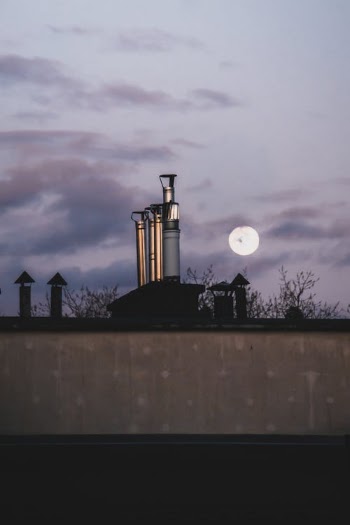 White and Black Concrete Building Under White Clouds during Night Time · Free Stock Photo