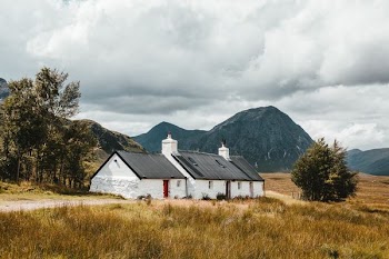 white and black house near mountain during daytime