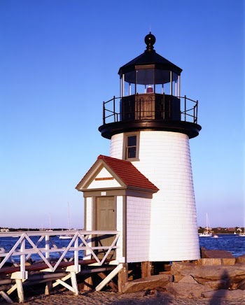White and Black Lighthouse Near Sea