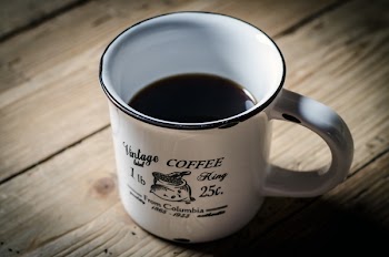 White and Black Mug With Black Liqour