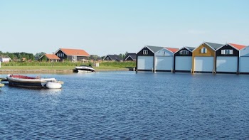 White and Black Powerboat Beside Green Grass
