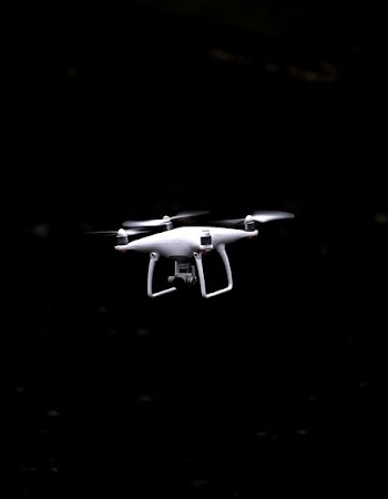 white and black quadcopter drone