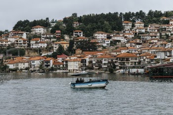 White and Blue Boat on Body of Water