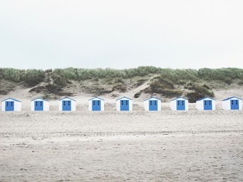 white and blue cabins in the middle of the desert