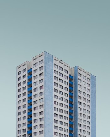 white and blue concrete high rise building