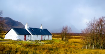 White and Blue House Under Cumulus Nimbus Clouds