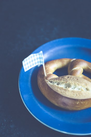 White and Blue Plastic Flag on Pastry on Blue Plastic Plate