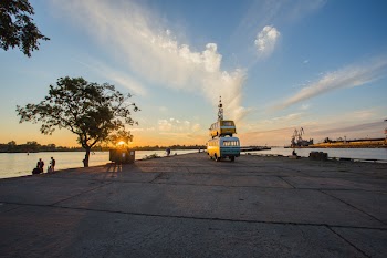 White and Blue Van Near People Gathering Near Body of Water