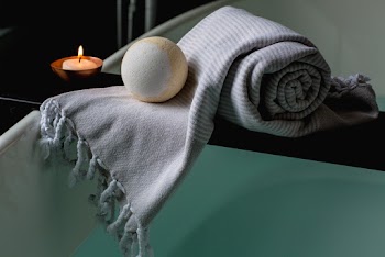 White and Brown Bath Ball on Grey Scarf