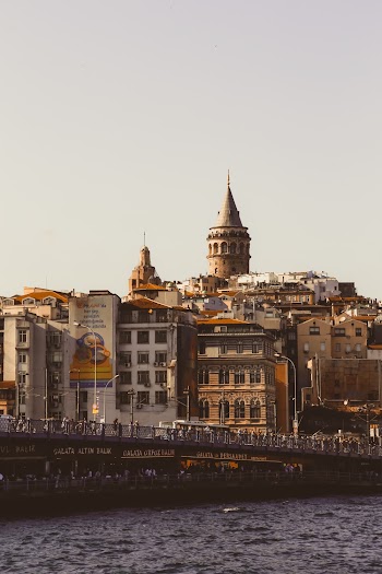 White and Brown Buildings Near Body of Water