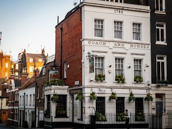 White and Brown Coach and Horses Concrete Building