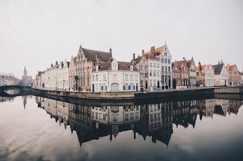 white and brown concrete buildings near bodies of water