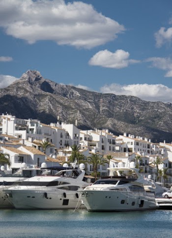 White and Brown Concrete Buildings Near Mountain Under Blue Sky