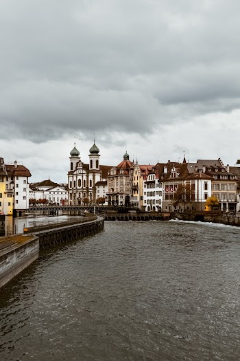 White and Brown Concrete Buildings Under Cloudy Sky