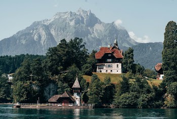 White and Brown Concrete House Near Body of Water