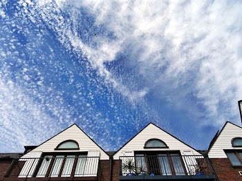 White and Brown Concrete House Under White Clouds