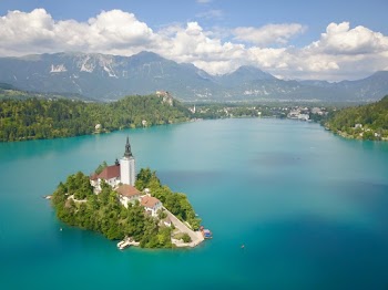 White and Brown House Surrounded by Body of Water