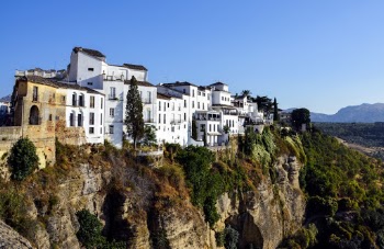 White and Brown Houses on Rocky Hill Across Woods