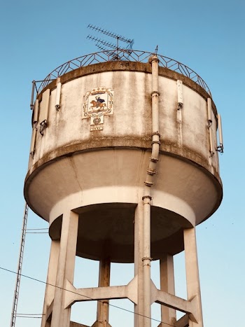 White and Brown Water Reservoir Under Clear Green and Blue Sky