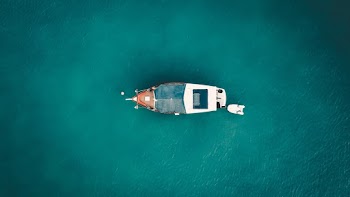 White and Gray Boat on Body of Water