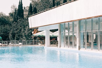 White and Gray Concrete Building Near Blue Swimming Pool