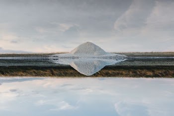white and gray field near body of water