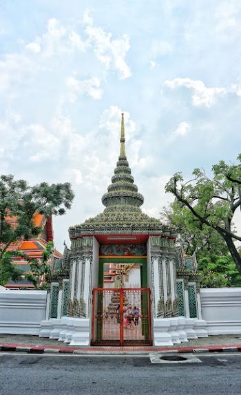 white and gray temple under blue cloudy sky at daytime