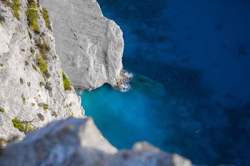 white and green cliff beside ocean