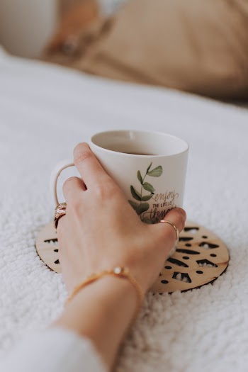White and Green Mug on Brown Cutout Mat