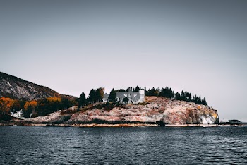 White and Grey House on Top of Hill in Island