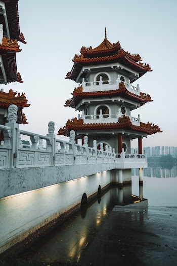 White and Maroon Temple Near Body of Water