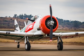 White and Orange Airplane on Runway