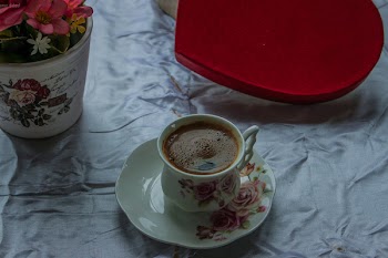White and Pink Ceramic Teacup Filled With Coffee on White Ceramic Saucer