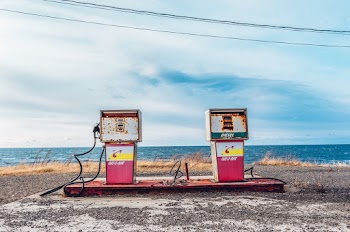 White and Pink Gasoline Station Near Ocean