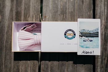 white and pink striped bowtie on box