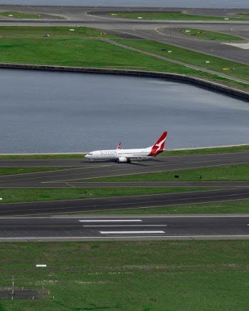 White and Red Airplane on Runway