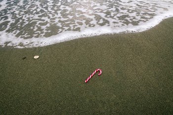White and Red Christmas Candy on Beach Sand