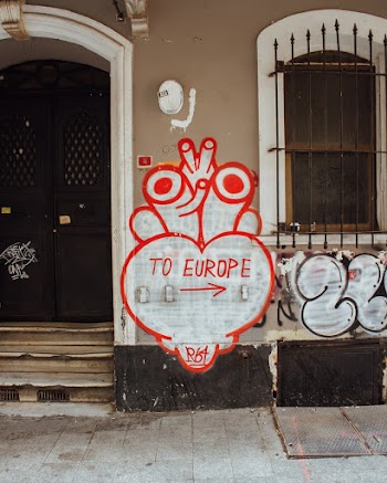 White and Red Heart to Europe Signage on Wall